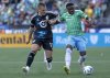 Seattle Sounders defender Nouhou Tolo, right, dribbles as Minnesota United midfielder Robin Lod (17) holds his arm during the first half of an MLS soccer match Sunday, June 1, 2025, in Seattle. (Nick Wagner/The Seattle Times via AP)