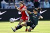 FILE - Kansas City Current midfielder Lo'eau LaBonta (10) plays the ball as Portland Thorns FC midfielder Jessie Fleming (21) challenges during an NWSL soccer match at CPKC Stadium, Saturday, March 16, 2024, in Kansas City, Mo. (AP Photo/Reed Hoffmann, File)