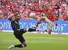 Mainz's Jonathan Burkhardt, right, vies for the ball with Leverkusen's Jonathan Tah, during the German Bundesliga soccer match between 1. FSV Mainz 05 and Bayer Leverkusen, at the Mewa Arena, in Mainz, Germany, Saturday, May 17, 2025. (Torsten Silz/dpa via AP)
