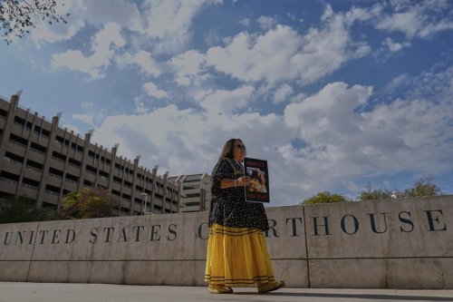 San Carlos Apache member Donna Cracium protests a massive copper mining project on federal land in Arizona outside the U.S. District Court, Wednesday, May 7, 2025, in Phoenix. (AP Photo/Matt York)