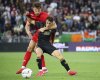 Venezia's Gaetano Oristanio, right, and Fiorentina's Marin Pongracic, left, challenge for the ball during the Serie A soccer match between Venezia and Fiorentina in Venice, Italy, Monday, May 12, 2025. (Paola Garbuio/LaPresse via AP)