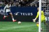 Vancouver Whitecaps' Sam Adekugbe, left, kicks the ball at Seattle Sounders goalkeeper Stefan Frei (24) missing the net during the first half of an MLS soccer match in Vancouver, on Wednesday, Oct. 2, 2024. THE CANADIAN PRESS/Ethan Cairns