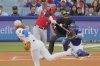 Los Angeles Angels' Yoan Moncada, second from left, hits a two-run home run as Los Angeles Dodgers starting pitcher Dustin May, left, watches along with catcher Will Smith during the first inning of a baseball game Friday, May 16, 2025, in Los Angeles. (AP Photo/Mark J. Terrill)