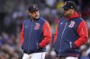 Boston Red Sox manager Alex Cora, left, walks back to the dugout with bench coach Ramon Vazquez after being ejected by home plate umpire Mike Estabrook during the third inning of a baseball game against the New York Mets at Fenway Park, Tuesday, May 20, 2025, in Boston. (AP Photo/Charles Krupa)