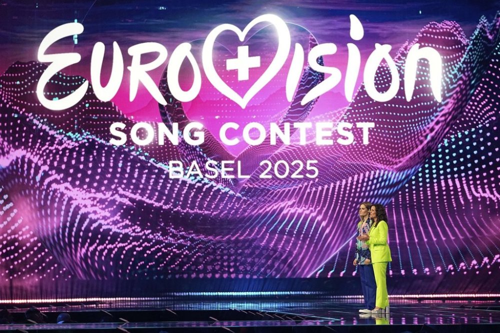 Hosts Hazel Brugger, left and Sandra Studer, on stage during the first semi-final of the 69th Eurovision Song Contest, in Basel, Switzerland, Tuesday, May 13, 2025. (AP Photo/Martin Meissner)
