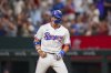 Texas Rangers' Josh Jung react after collecting an RBI single to score Sam Haggerty during the eighth inning of a baseball game against the Toronto Blue Jays Tuesday, May 27, 2025, in Arlington, Texas. (AP Photo/Julio Cortez)