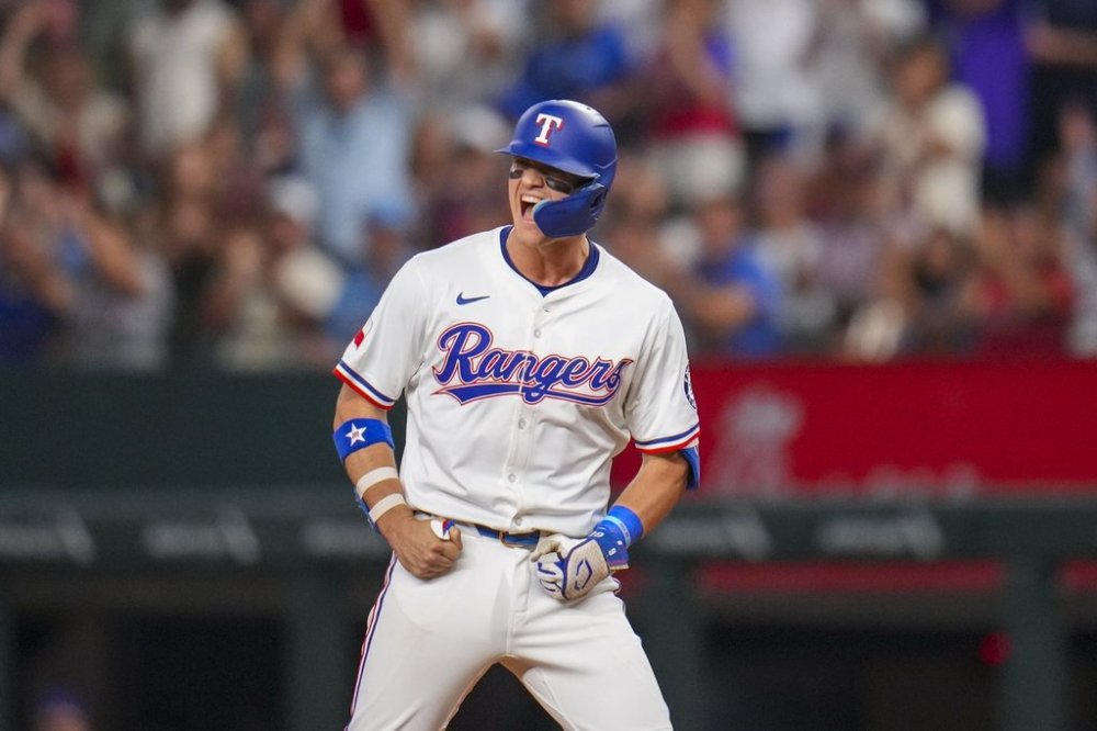 Texas Rangers' Josh Jung react after collecting an RBI single to score Sam Haggerty during the eighth inning of a baseball game against the Toronto Blue Jays Tuesday, May 27, 2025, in Arlington, Texas. (AP Photo/Julio Cortez)