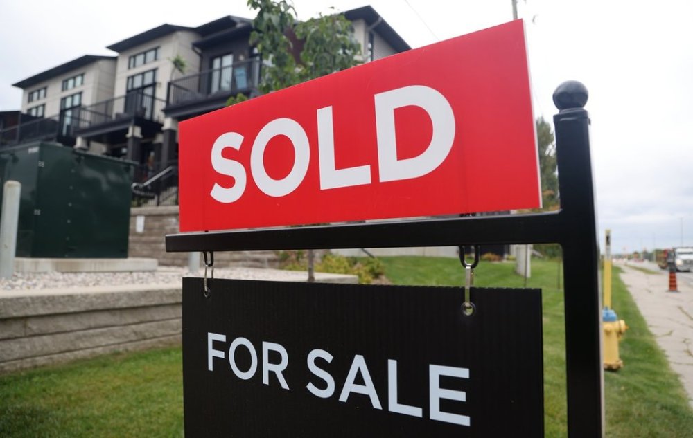 A for sale/sold sign stands in front of residential homes in the Riverside South neighbourhood of Ottawa on Friday, Aug. 30, 2024. THE CANADIAN PRESS/ Patrick Doyle