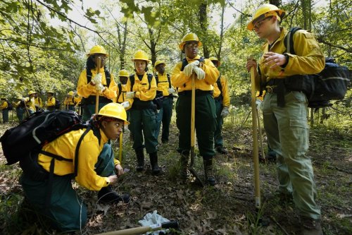 FILE - Students listen to instruction from instructor Ben McLane, right, during a wildland firefighter training, June 9, 2023, in Hazel Green, Ala. (AP Photo/George Walker IV, File)