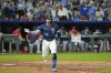 Kansas City Royals' Freddy Fermin celebrates as he runs to first after hitting an RBI single to win the game during the 12th inning of a baseball game against the Boston Red Sox, Friday, May 9, 2025, in Kansas City, Mo. (AP Photo/Charlie Riedel)