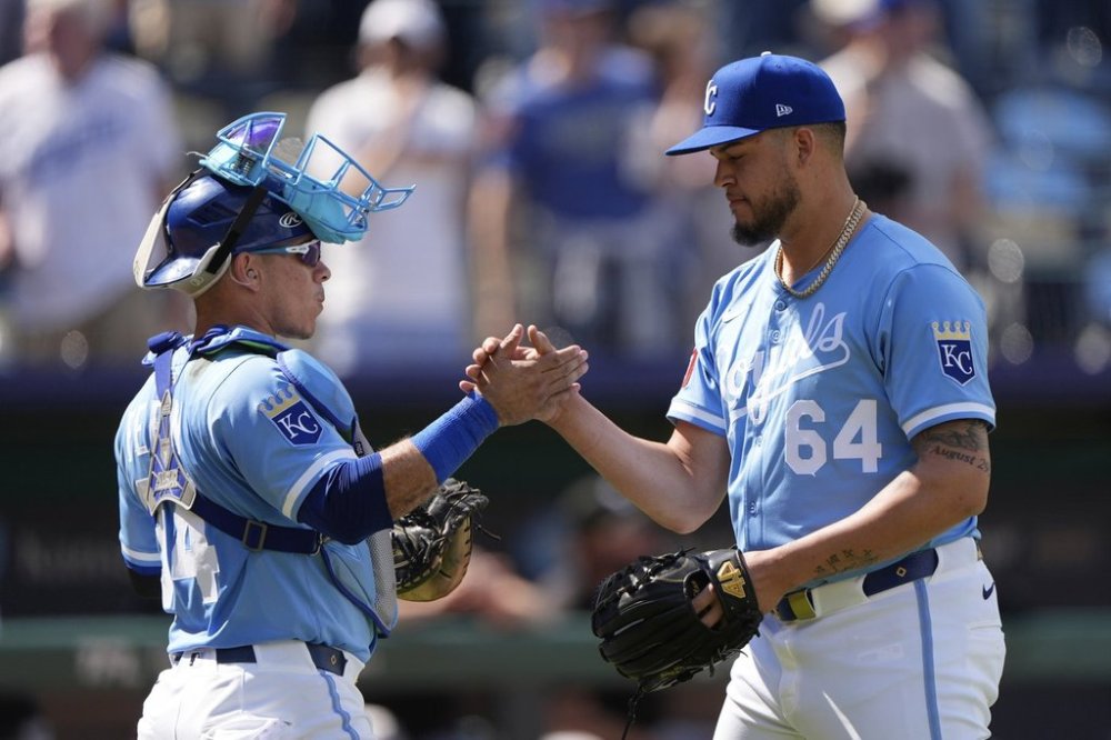 Kansas City Royals catcher Freddy Fermin, left, and relief pitcher Steven Cruz (64) celebrate after their baseball game against the Chicago White Sox, Thursday, May 8, 2025, in Kansas City, Mo. (AP Photo/Charlie Riedel)