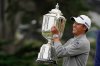 FILE - Collin Morikawa holds the Wanamaker Trophy after winning the PGA Championship golf tournament at TPC Harding Park Sunday, Aug. 9, 2020, in San Francisco. (AP Photo/Charlie Riedel, File)