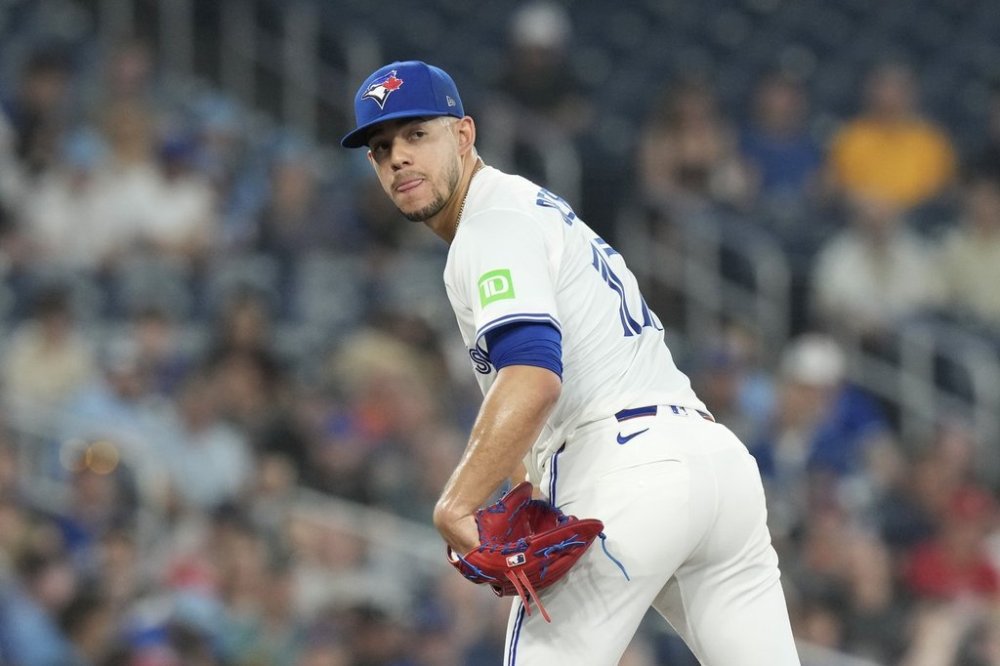 Toronto Blue Jays pitcher Jose Berrios (17) checks on a Philadelphia Phillies runner on first base during third inning MLB baseball action in Toronto on Wednesday, June 4, 2025. THE CANADIAN PRESS/Chris Young