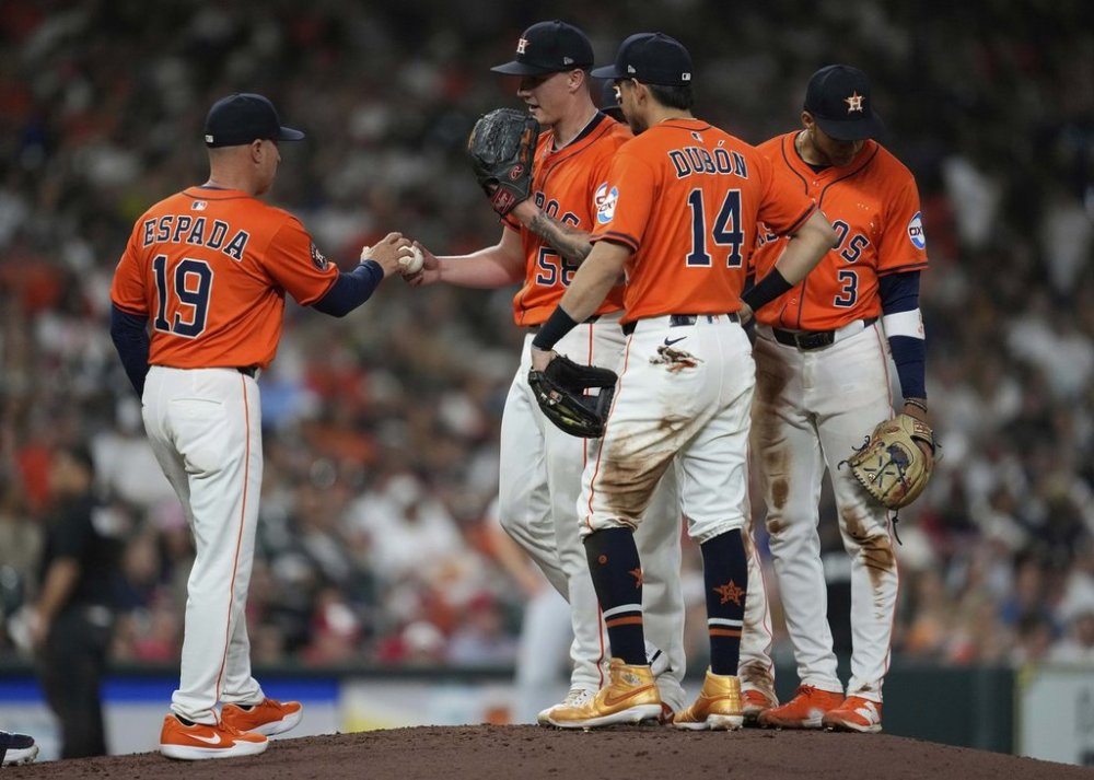 Houston Astros manager Joe Espada (19) pulls starting pitcher Hunter Brown (58) from the game during the sixth inning of a baseball game against the Cincinnati Reds in Houston, Friday, May 9, 2025. (AP Photo/Ashley Landis)
