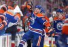 Oilers forwards Corey Perry (90) and Ryan Nugent-Hopkins, back right, celebrate Perry's tying goal against the Florida Panthers during the third period in Game 2 of the Stanley Cup final in Edmonton, on Friday, June 6, 2025. THE CANADIAN PRESS/Darryl Dyck