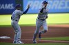 Los Angeles Dodgers' Shohei Ohtani, right, is congratulated by third base coach Dino Ebel, left, after hitting a solo home run off Cleveland Guardians starting pitcher Gavin Williams during the first inning of a baseball game, Monday, May 26, 2025, in Cleveland. (AP Photo/David Dermer)