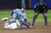 Los Angeles Dodgers second baseman Tommy Edman, top left, catches New York Mets' Starling Marte, bottom left, stealing second base during the seventh inning of a baseball game, Sunday, May 25, 2025, in New York. (AP Photo/Seth Wenig)