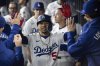 Los Angeles Dodgers' Mookie Betts celebrates in the dugout after hitting a solo home run during the sixth inning of a baseball game against the Arizona Diamondbacks in Los Angeles, Monday, May 19, 2025. (AP Photo/Kyusung Gong)