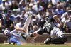 Chicago Cubs' Michael Busch left, slides into home plate safely as Chicago White Sox catcher Matt Thaiss (29) attempts to apply the tag during the second inning of a baseball game Friday, May 16, 2025, in Chicago. (AP Photo/Paul Beaty)