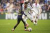 FILE - Lyon's Rayan Cherki, right, is challenged by Reims' Mamadou Diakhon during the French League One soccer match between Lyon and Reims at the Groupama stadium in Decines, outside Lyon, central France, Feb. 9, 2025. (AP Photo/Laurent Cipriani, File)