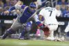 Miami Marlins' Jesus Sanchez (7) beats the throw to Chicago Cubs catcher Miguel Amaya, left, to score on a single hit by Otto Lopez during the fifth inning of a baseball game Monday, May 19, 2025, in Miami. (AP Photo/Lynne Sladky)