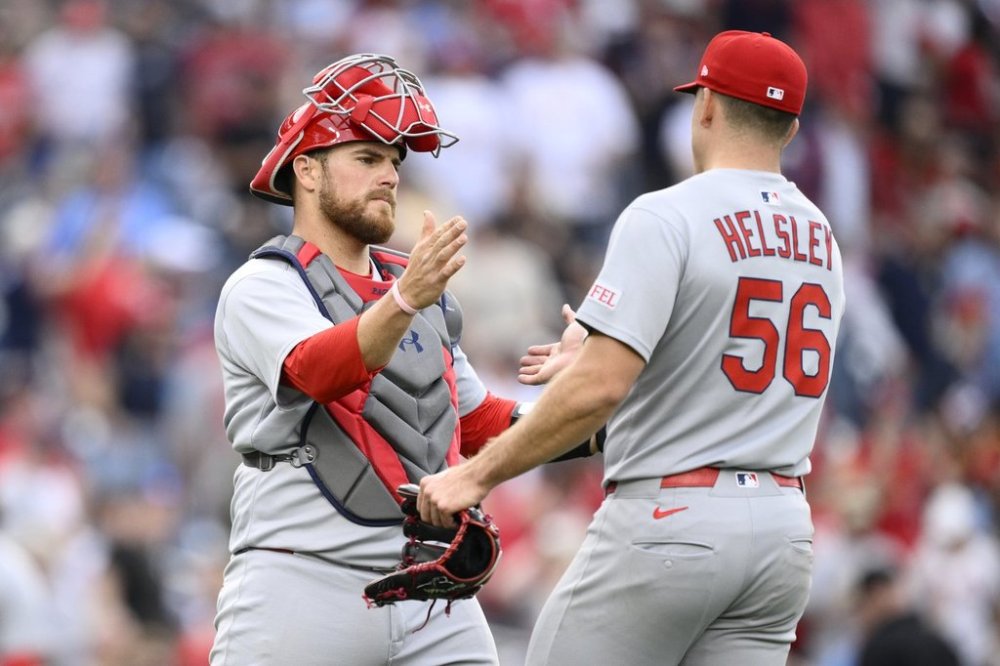 St. Louis Cardinals catcher Pedro Pages, left, and relief pitcher Ryan Helsley (56) celebrate after a baseball game against the Washington Nationals, Saturday, May 10, 2025, in Washington. (AP Photo/Nick Wass)