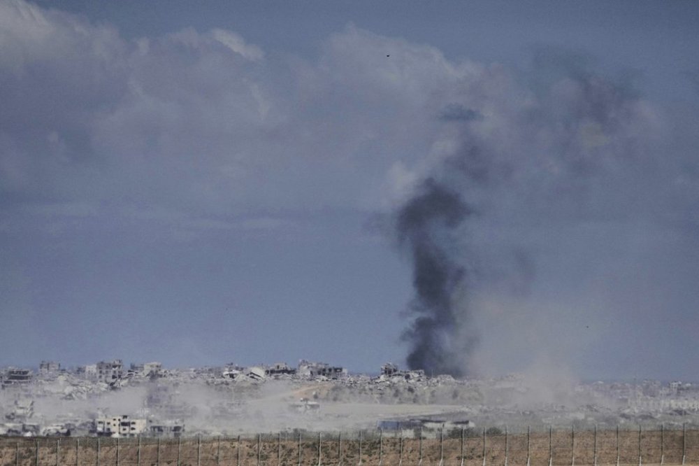 Smoke from Israeli bombardment billows over buildings in the northern Gaza Strip, seen from southern Israel, Monday, June 2, 2025. (AP Photo/Maya Alleruzzo)