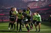 Sporting's Francisco Trincao, center, is congratulated after scoring his side's opening goal during a Portuguese league soccer match between SL Benfica and Sporting CP at the Luz stadium in Lisbon, Saturday, May 10, 2025. (AP Photo/Armando Franca)