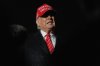 President Donald Trump speaks to reporters in the rain after arriving on Air Force 1 at Joint Base Andrews, Md., Friday, May 30, 2025. (AP Photo/Julia Demaree Nikhinson)