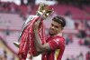 Liverpool's Luis Diaz poses with the winner's trophy after the English Premier League soccer match between Liverpool and Crystal Palace at the Anfield stadium in Liverpool, England, Sunday, May 25, 2025. (AP Photo/Jon Super)