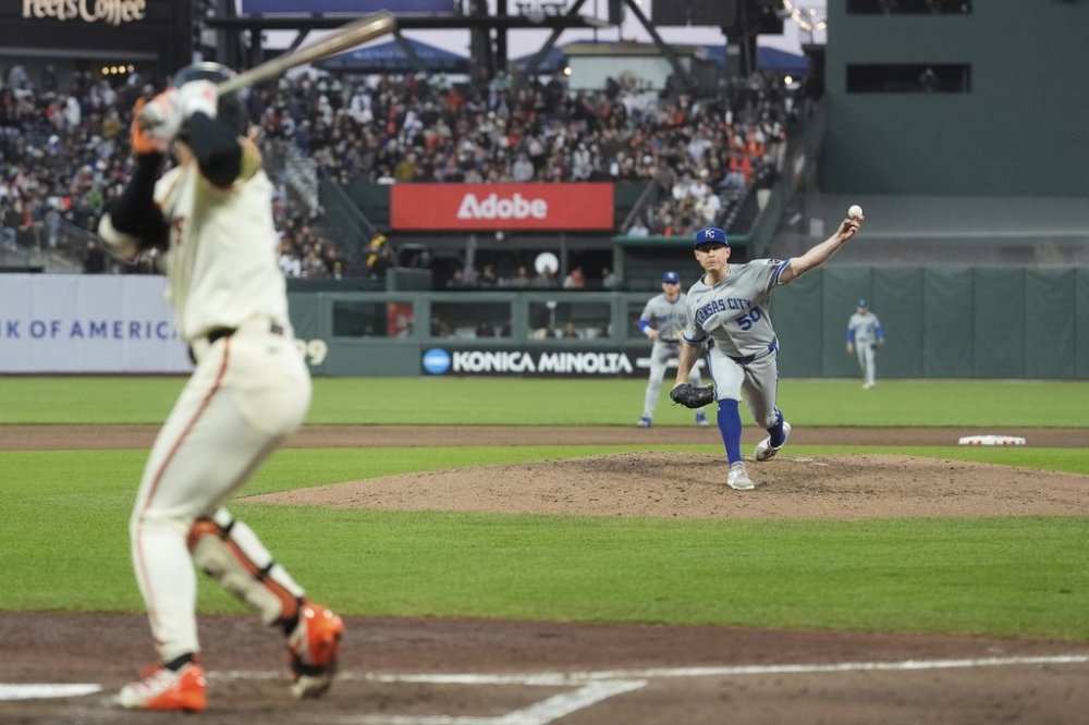 Kansas City Royals pitcher Kris Bubic (50) throws a pitch to San Francisco Giants' Jung Hoo Lee, left, during the sixth inning of a baseball game in San Francisco, Monday, May 19, 2025. (AP Photo/Jeff Chiu)