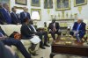 President Donald Trump meets South African President Cyril Ramaphosa in the Oval Office of the White House, Wednesday, May 21, 2025, in Washington, as South African businessman Johann Rupert, looks on, upper left. (AP Photo/Evan Vucci)