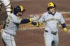 Milwaukee Brewers' Christian Yelich, right, is greeted by Rhys Hoskins as he returns to the dugout after hitting a solo home run off Pittsburgh Pirates pitcher Isaac Mattson during the sixth inning of a baseball game in Pittsburgh, Thursday, May 22, 2025. (AP Photo/Gene J. Puskar)