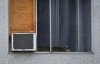 A cat sleeps in an apartment window beside an air conditioner in Burnaby, B.C. on August 5, 2023. THE CANADIAN PRESS/Darryl Dyck