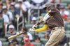 San Diego Padres' Manny Machado hits a double in the first inning of a baseball game against the Atlanta Braves, Sunday, May 25, 2025, in Atlanta. (AP Photo/Colin Hubbard)