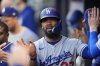 Los Angeles Dodgers' Teoscar Hernández (37) celebrates a run off the batt of Los Angeles Dodgers third baseman Max Muncy (13) in the fourth inning of a baseball game against the Atlanta Braves, Sunday, May 4, 2025, in Atlanta. (AP Photo/Mike Stewart)