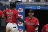 Cleveland Guardians manager Stephen Vogt, right, greets Jose Ramirez (11) as he returns to the dugout after scoring in the sixth inning of a baseball game against the Milwaukee Brewers in Cleveland, Monday, May 12, 2025. (AP Photo/Sue Ogrocki)
