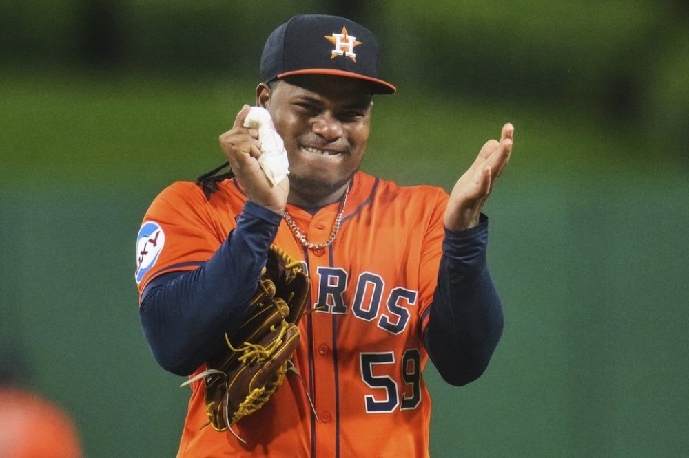 Houston Astros pitcher Framber Valdez gets rosin on his hand before delivering a pitch during the first inning of a baseball game against the Pittsburgh Pirates in Pittsburgh, Thursday, June 5, 2025. (AP Photo/Gene J. Puskar)