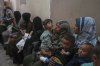 Palestinian women wait with their sick children for medical care in an overcrowded clinic in Gaza City, Wednesday, May 28, 2025. (AP Photo/Jehand Alshrafi)