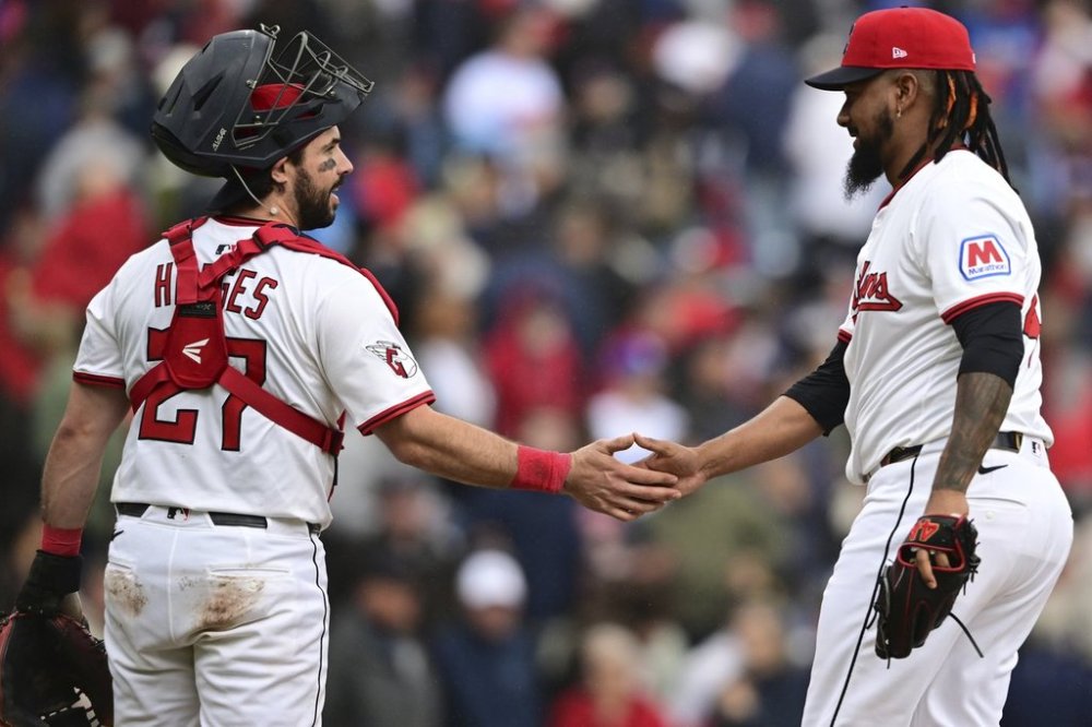 Cleveland Guardians relief pitcher Emmanuel Clase is congratulated by catcher Austin Hedges after the Guardians defeated the Los Angeles Dodgers in a baseball game, Wednesday, May 28, 2025, in Cleveland. (AP Photo/David Dermer)