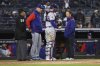 Texas Rangers catcher Jonah Heim talks to staff before leaving the field due to an apparent injury during the second inning of a baseball game against the New York Yankees, Wednesday, May 21, 2025, in New York. (AP Photo/Pamela Smith)