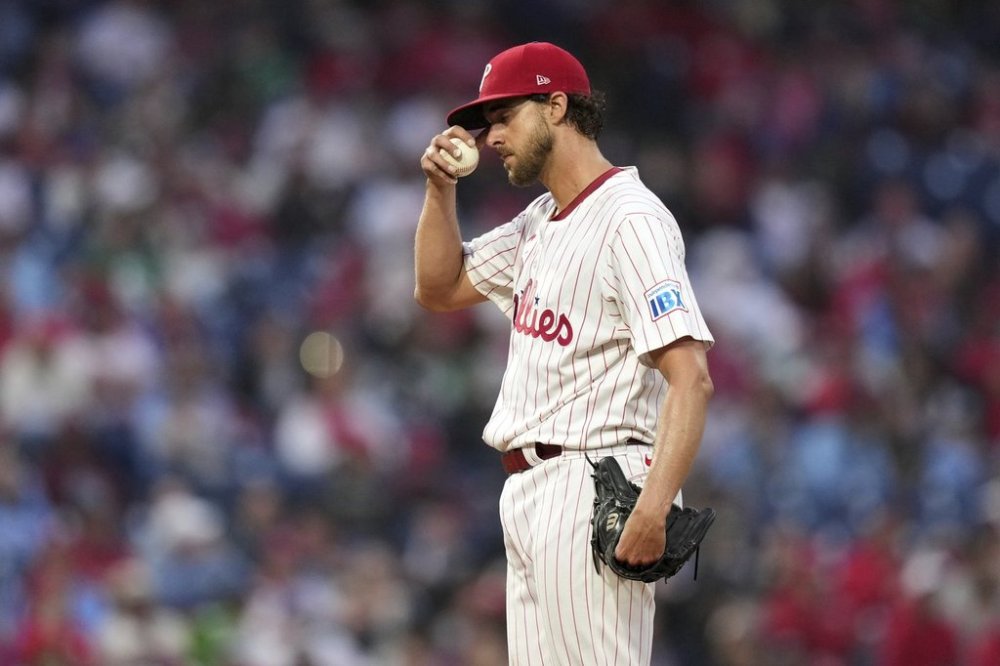 Philadelphia Phillies pitcher Aaron Nola wipes his face during the fourth inning in the second baseball game of a doubleheader against the St. Louis Cardinals Wednesday, May 14, 2025, in Philadelphia. (AP Photo/Matt Slocum)