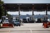 A Canada Border Services Agency officer is silhouetted as motorists enter Canada at the Douglas-Peace Arch border crossing, in Surrey, B.C., on Monday, Aug. 9, 2021. THE CANADIAN PRESS/Darryl Dyck