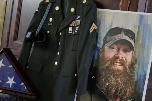 The Army dress uniform and photo of the late Christopher Pelkey is shown at his mother's home, Wednesday, May 7, 2025, in Chandler, Ariz. (AP Photo/Matt York)