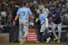 Tampa Bay Rays' Taylor Walls, center, is held back after he's ejected by Umpire Nic Lentz, left, for tapping his helmet after a strike call during the ninth inning of a baseball game against the Houston Astros in Houston, Sunday, June 1, 2025. (AP Photo/Ashley Landis)