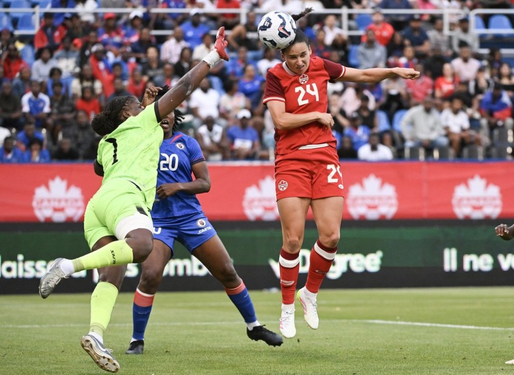 Canada's Evelyne Viens (24) scores against Haiti's goalkeeper Kaina Cesar Pietrus (1) during first half international friendly soccer action in Montreal, Tuesday, June 3, 2025. THE CANADIAN PRESS/Graham Hughes