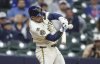 Milwaukee Brewers Caleb Durbin hits a game-winning sacrifice fly during the tenth inning against the Boston Red Sox during a baseball game, Wednesday, May 28, 2025, in Milwaukee. (AP Photo/Jeffrey Phelps)