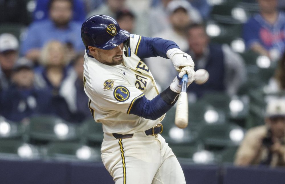 Milwaukee Brewers Caleb Durbin hits a game-winning sacrifice fly during the tenth inning against the Boston Red Sox during a baseball game, Wednesday, May 28, 2025, in Milwaukee. (AP Photo/Jeffrey Phelps)