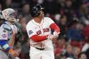 Boston Red Sox designated hitter Rafael Devers watches the flight of his solo home run during the fifth inning of a baseball game against the New York Mets at Fenway Park, Tuesday, May 20, 2025, in Boston. (AP Photo/Charles Krupa)