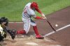 Cincinnati Reds' Austin Hays (12) singles off Pittsburgh Pirates pitcher David Bednar, driving in a run, during the eighth inning of a baseball game in Pittsburgh, Monday, May 19, 2025. (AP Photo/Gene J. Puskar)